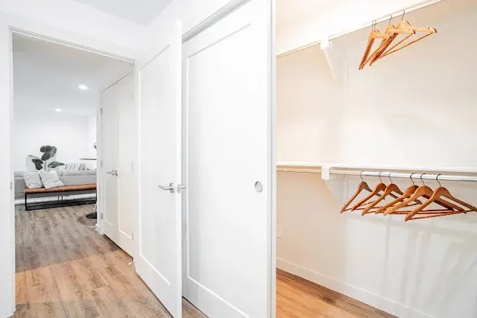 Reach-in closet with a shelf and rod opening to the bedroom