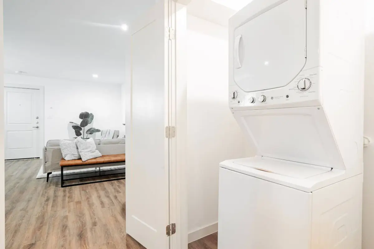 In-unit stacked washer and dryer in a closet beside the living area