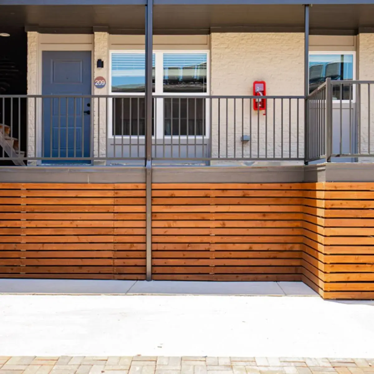 Parkside Green covered entry with cedar-slat screening and unit balconies
