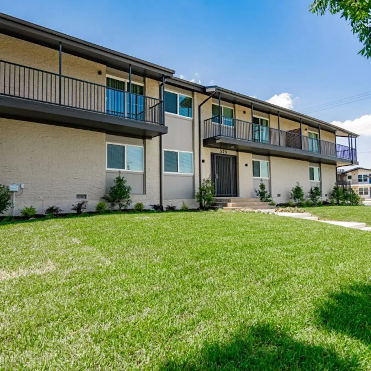 Parkside Green two-story brick exterior with private balconies and lawn