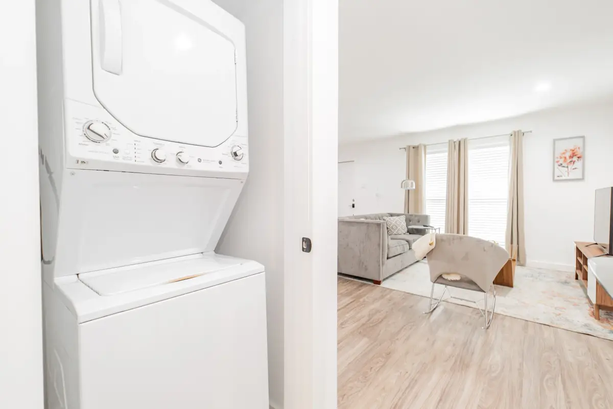 In-unit stacked washer and dryer in a closet beside the living area