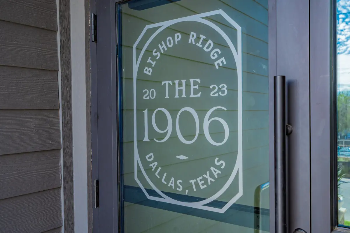 Etched Bishop Ridge and The 1906 seal on the glass entry door, framed in bronze with a long bar pull
