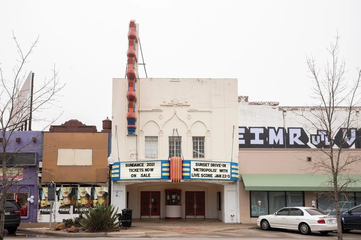 Storefronts and a vintage theater marquee along Jefferson Boulevard in Oak Cliff
