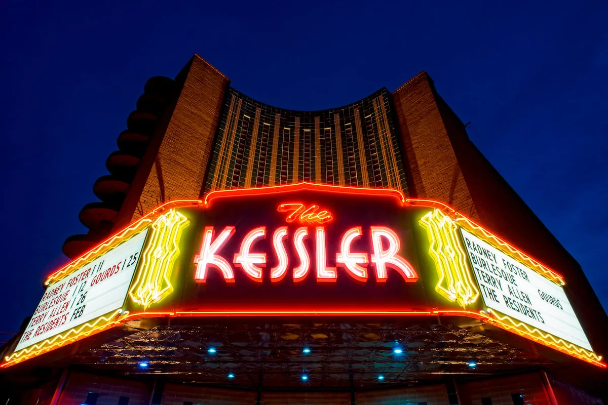 The neon marquee of the historic Kessler Theater lit up at night in Oak Cliff