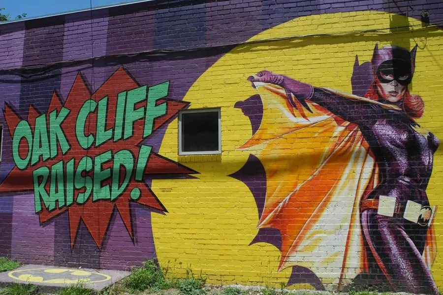 A colorful "Oak Cliff Raised" street mural in North Oak Cliff