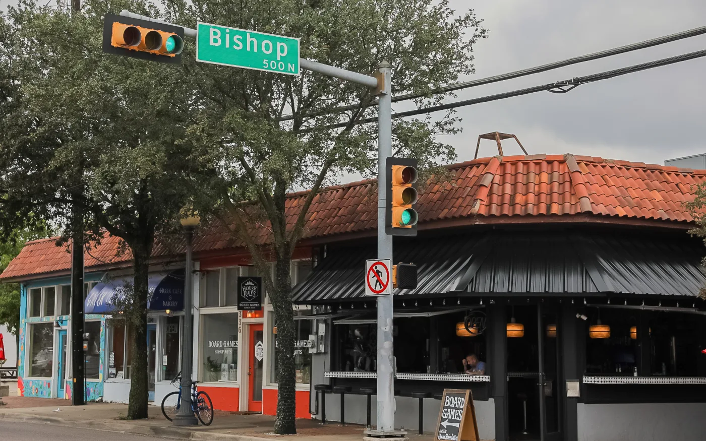 The Bishop Avenue street sign at a corner of red tile roofs in the Bishop Arts District