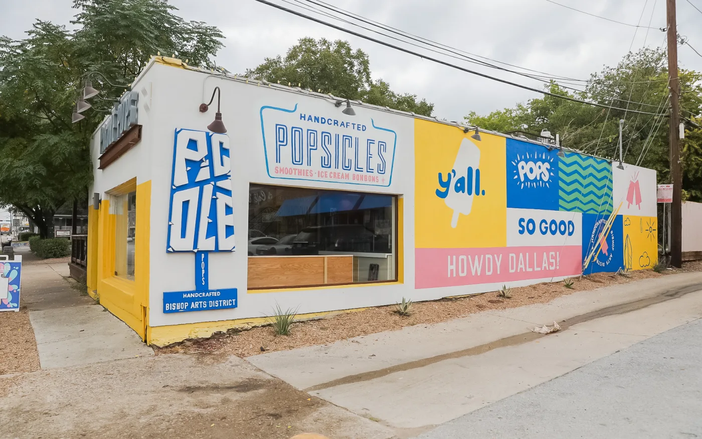 The painted popsicle-shop wall reading Howdy Dallas in the Bishop Arts District